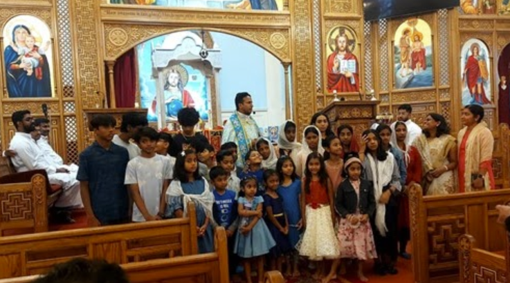 Children and young people from catechism classes gathered in the church sanctuary with teachers and parents