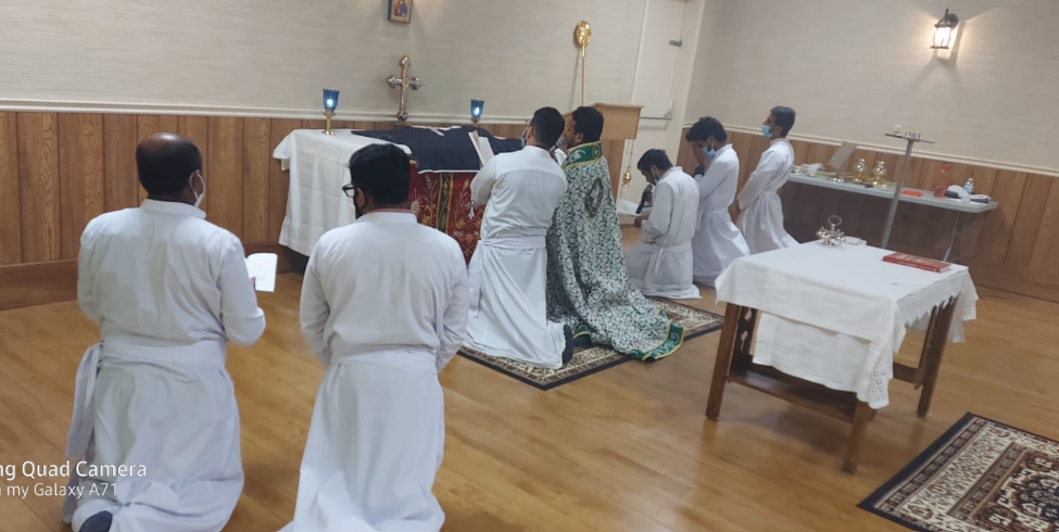Clergy members in white vestments during church service